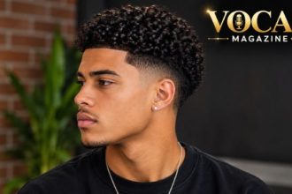 Low Taper Fade Curly Hair with natural textured curls and a clean, low fade around the sideburns and neckline